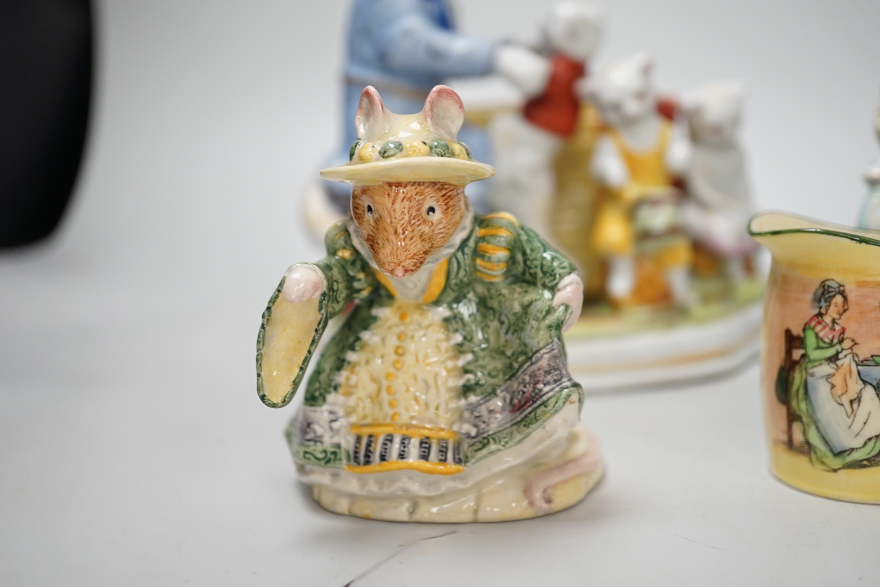 A collection of Royal Doulton figures and five character mugs, tallest 16.5cm high